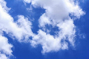 Blue sky background with white clouds. The vast blue sky and clouds sky on sunny day. White fluffy clouds in the blue sky.