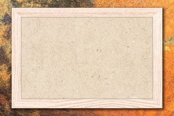 Fototapeta premium Chipboard or Empty bulletin board with a wooden frame on cement wall background with copy space for text or image.