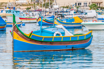 Fototapeta na wymiar Traditional Luzzu boat at Marsaxlokk harbor in Malta.