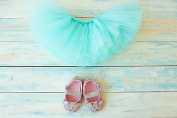 Tutu skirt with booties on turquoise wooden background