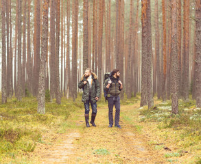 Fototapeta premium Man with a backpack and beard and his friend in forest