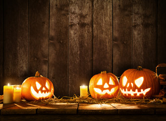 Scary halloween pumpkins on wooden planks