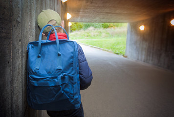 School child walking in a dark subway