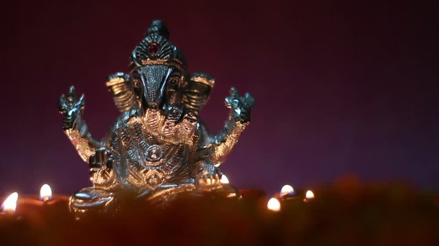 lord ganesha with earthen lamp illuminated, festival or puja celebration