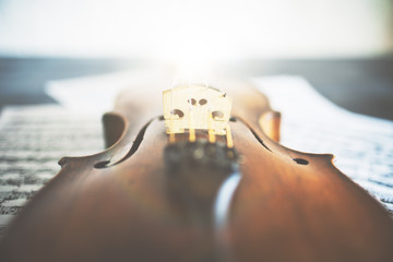 Violin placed on music sheets