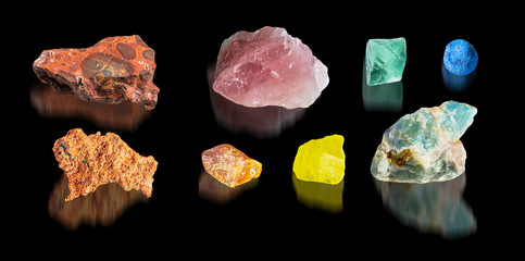 Rainbow set of colorful minerals isolated on black background with mirror reflections