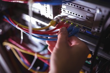 Close-Up of technician plugging patch cable