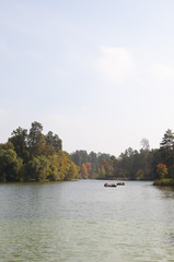 Fototapeta premium boat on lake near autumn forest