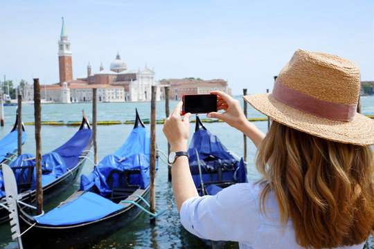 Canal and gondolas with tourist eye