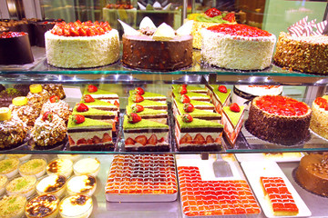Pastry shop display window with cakes