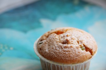 a cupcake with candied fruit on the table