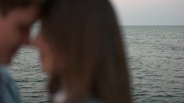 couple kissing on the background of the sea.