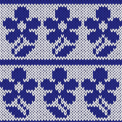 Knitting ornate seamless colourful pattern with dark blue flower