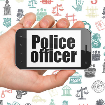 Law concept: Hand Holding Smartphone with Police Officer on display