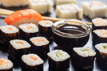 Sushi rolls on a black surface