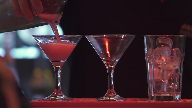 Cocktail preparation in a bar - pouring (slow motion from 100fps)
