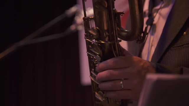 Close up of saxophone with fingers on keys