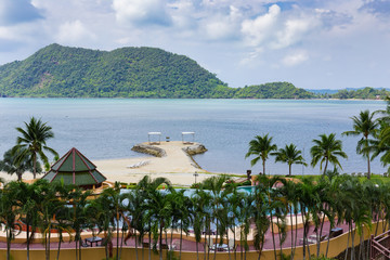 Bungalows in a tropical garden on the beach