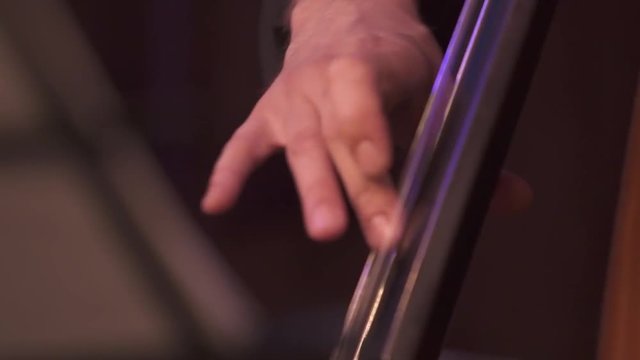 Big close up of hand playing bass (slow motion from 100fps)