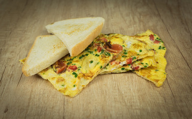 Toast with egg omelette on wooden table