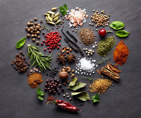 Spices with herbs on a graphite board