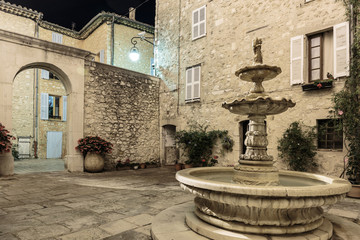 Fototapeta na wymiar Patio with fountain in the old village at night, France.