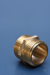 Brass fittings for water and gas on blue metal surface