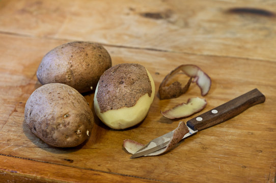 Potatoes and knife on table