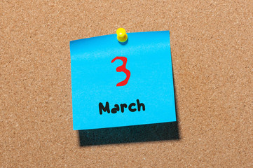 March 3rd. Day 3 of month, calendar on cork notice board background. Spring time, empty space for text