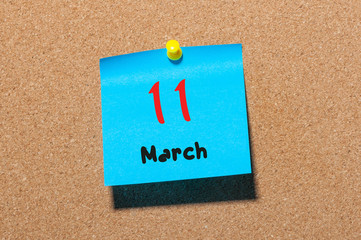 March 11th. Day 11 of month, calendar on cork notice board background. Spring time, empty space for text