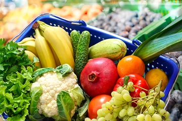 Fotobehang Basket with fruits and vegetables on a supermarket background © hacohob
