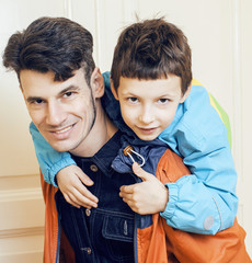 young handsome father with his son fooling around at home, lifestyle people concept