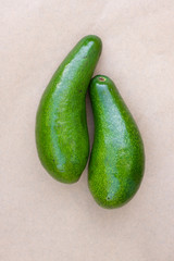 Pair of raw avocados lay on gray background. Yin yang harmony