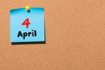 April 4th. Day 4 of month, calendar on cork notice board, business background. Spring time, empty space for text