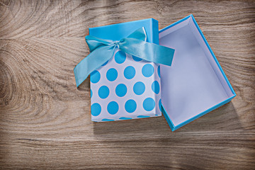Blue wrapped gift box on wooden board celebrations concept