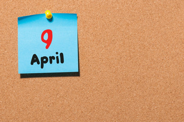 April 9th. Day 9 of month, calendar on cork notice board, business background. Spring time, empty space for text