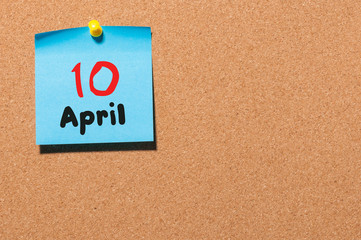 April 10th. Day 10 of month, calendar on cork notice board, business background. Spring time, empty space for text