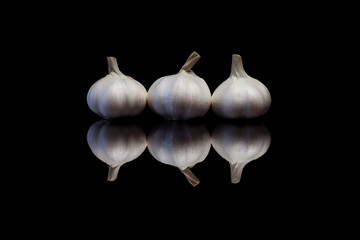 Three garlic on a black background