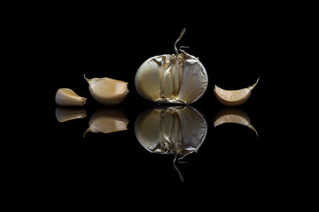 Garlic isolated on a black reflective background