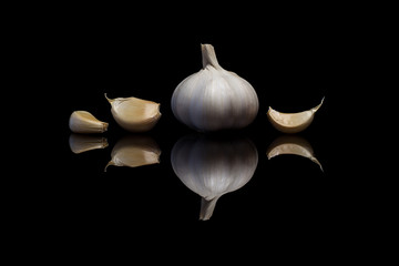 Garlic isolated on a black reflective background