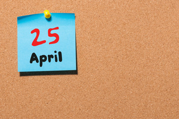 April 25th. Day 25 of month, calendar on cork notice board, business background. Spring time, empty...