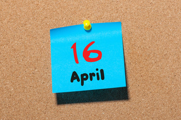 April 16th. Day 16 of month, calendar on cork notice board, business background. Spring time, empty space for text