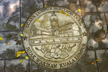 KUALA LUMPUR, MALAYSIA - JANUARY 16, 2016: round memorial pate on ground - symbol of the city.