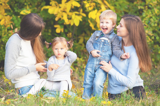 Alternative lesbian family with mothers, daughter and boy outdoor