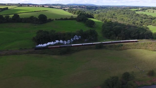 Aerial view of a steam train and spectators.