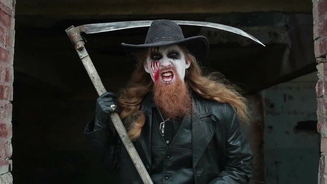 Horrible maniac with a scythe, shouting and threatening.