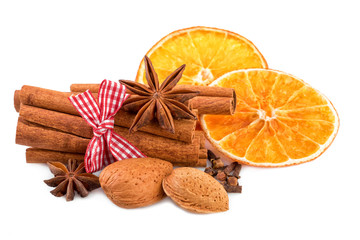 Christmas spices cinnamon anise cloves almond nuts dried orange isolated on white