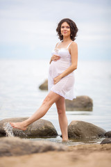 Pregnant woman resting on the beach
