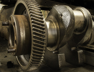 Close up of a crank shaft showing cog and camshaft.