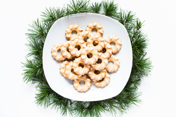 Christmas biscuits on a dish on white background